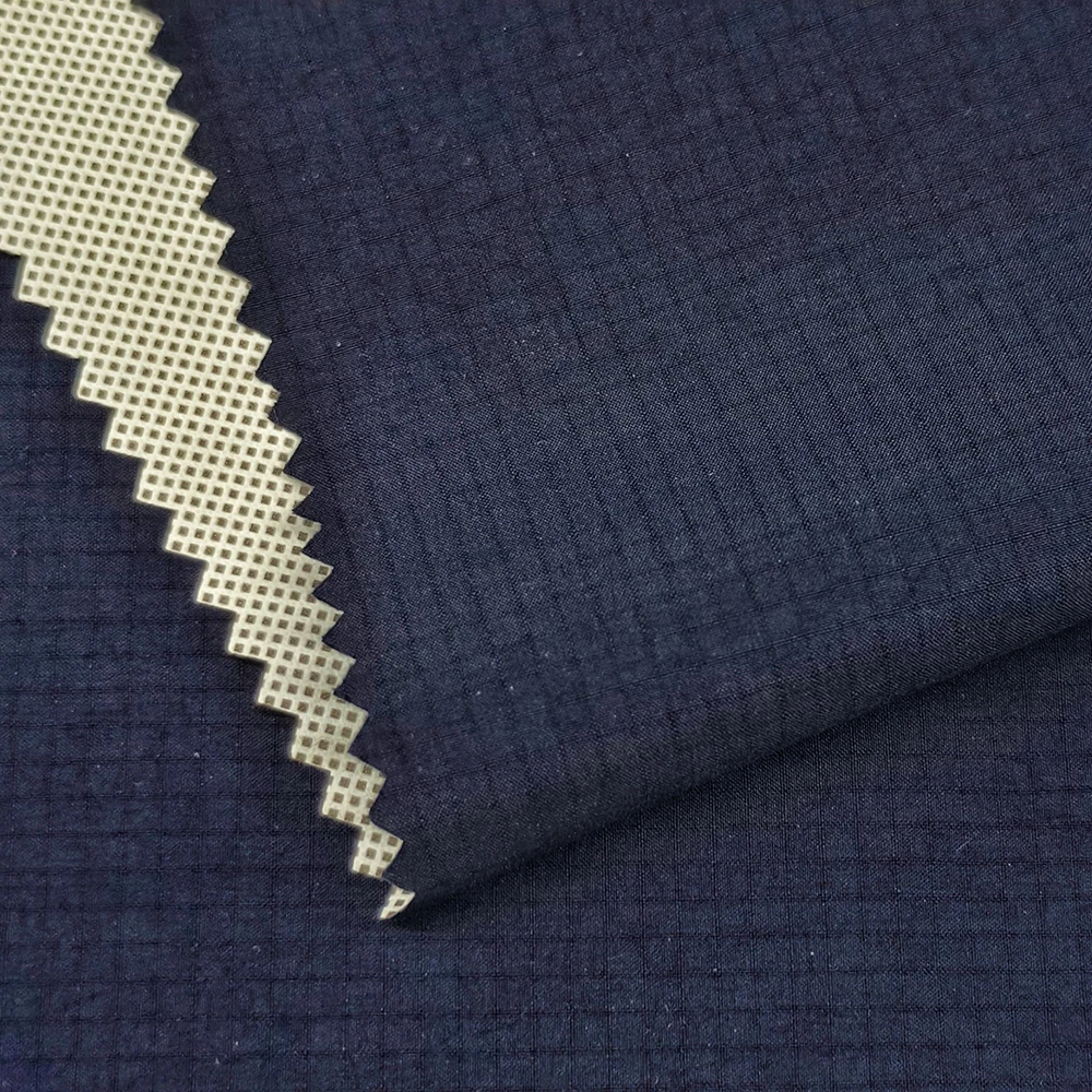 Close-up of 40D nylon ripstop stretch fabric showing grid surface texture and contrast backing structure